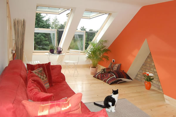 Loft room with painted chimney breast and balcony-style velux windows